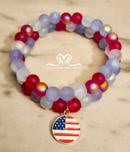 Load image into Gallery viewer, 🇺🇸 Celebrate America's 250th Independence Day! 🇺🇸

NEW! Celebrate in style with our one-of-a-kind, handcrafted 7.5-inch red, white, and blue stackable bracelet, featuring glass beads beautifully accented with an American flag charm.
