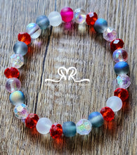 Load image into Gallery viewer, 🇺🇸 Celebrate America's 250th Independence Day! 🇺🇸

NEW! Celebrate in style with our one-of-a-kind, handcrafted 7.5-inch red, white, and blue stackable bracelet, featuring glass beads beautifully accented with an American flag charm.