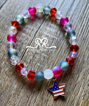 Load image into Gallery viewer, 🇺🇸 Celebrate America's 250th Independence Day! 🇺🇸

NEW! Celebrate in style with our one-of-a-kind, handcrafted 7.5-inch red, white, and blue stackable bracelet, featuring glass beads beautifully accented with an American flag charm.
